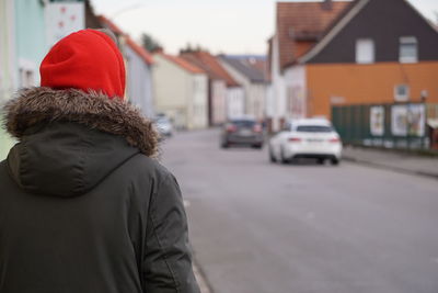 Rear view of man on street in city