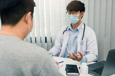 Doctor examining patient in clinic