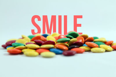 Close-up of multi colored candies against white background