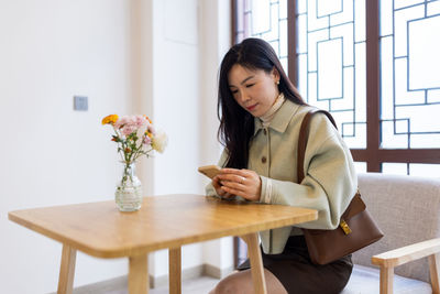 Businesswoman using phone at office