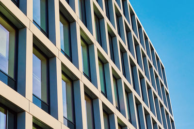 Modern building facade with windows against blue sky
