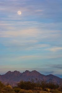 Scenic view of mountains against sky at sunset