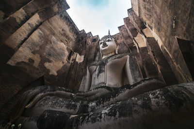 Low angle view of statue against historic building