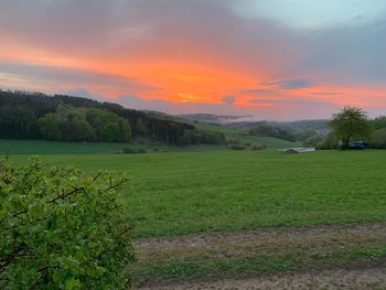 Scenic view of field against sky during sunset