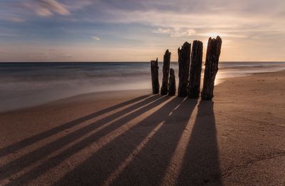 Scenic view of beach against sky during sunset