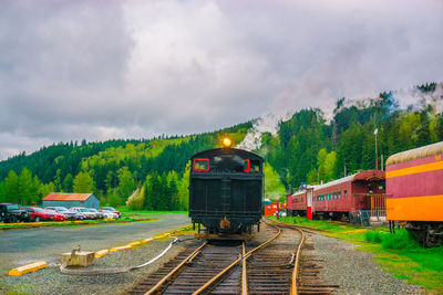 Train on railroad track against sky