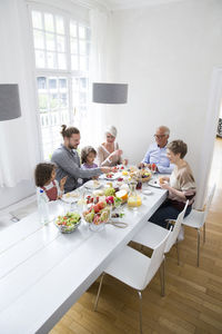 Happy extended family having lunch at home