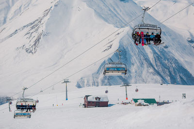 Ski lift on snowcapped mountains