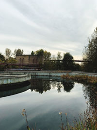 Reflection of building in lake against sky