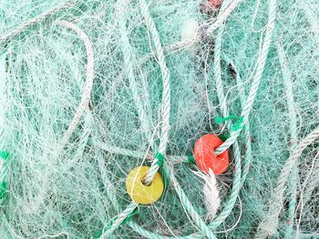 Close-up of fishing net hanging on rope