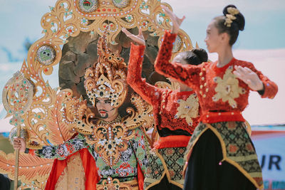 Midsection of woman dancing in traditional clothing during festival