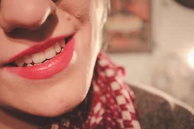 Midsection of smiling young woman at home