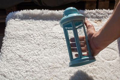 Close-up of person holding ice cream on rug