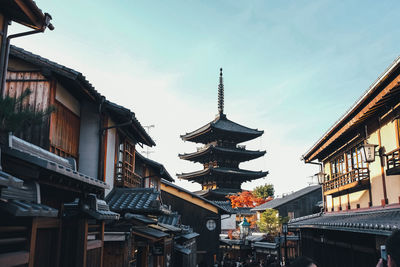 Low angle view of pagoda against buildings