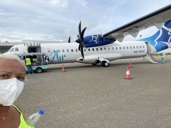 Portrait of man on airport runway against sky