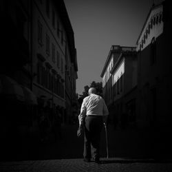 Rear view of man walking on street