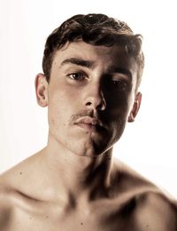 Portrait of young man against white background