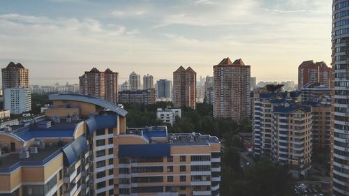 Buildings against cloudy sky