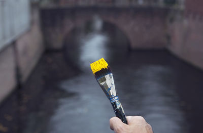 Close-up of hand holding umbrella