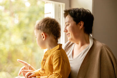 Happy grandmother and grandson enjoy time together. positive middle age woman 