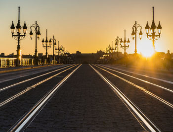 View of street lights against sky during sunset