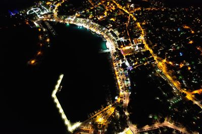 Aerial view of illuminated buildings in city at night