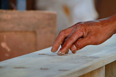 Cropped hand of carpenter working in workshop