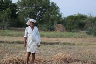 Farmer standing on field at farm