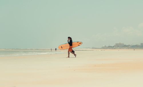 Two people running on beach