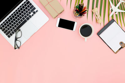 High angle view of laptop and coffee cup on table