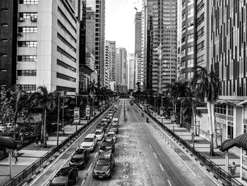 Traffic on road amidst buildings in city