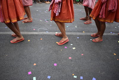 Low section of women dancing on road