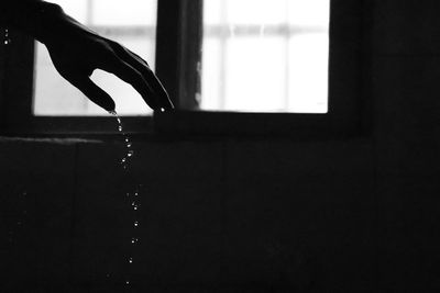 Close-up of water falling from glass window at home