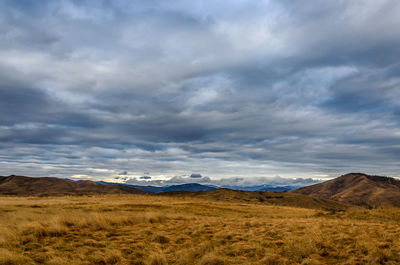 Scenic view of mountains against cloudy sky