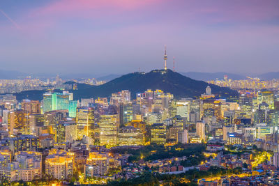 Illuminated cityscape against sky