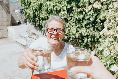 Portrait of smiling woman having drink