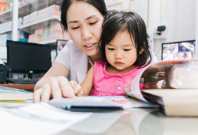 Close-up of mother and girl using smart phone