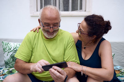 Midsection of man using mobile phone