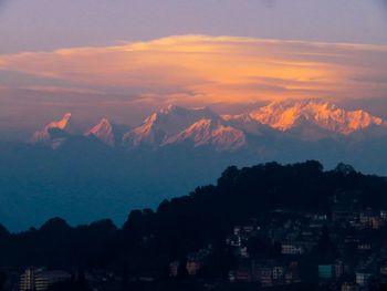 Scenic view of silhouette mountains against romantic sky at sunset