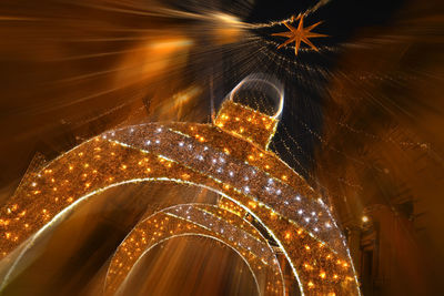 Low angle view of illuminated ferris wheel at night