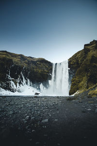 Scenic view of waterfall against clear sky