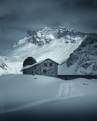 Scenic view of snow covered mountains against sky