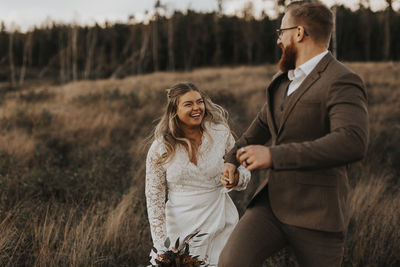 Happy young couple on field