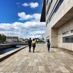 Rear view of man walking on city street