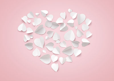 Close-up of heart shape against pink background