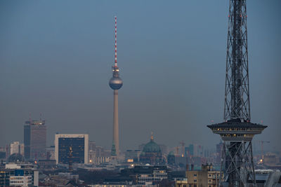 Communications tower in city at night