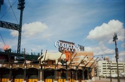 Low angle view of text on building against sky