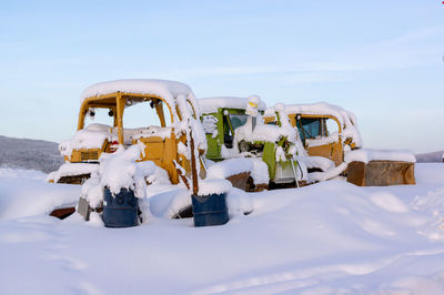 Panoramic view of snow covered land against sky