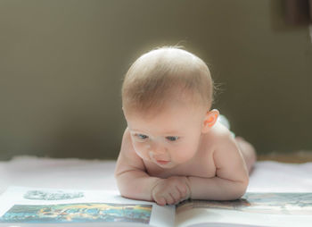 Close-up of cute baby boy looking at picture book