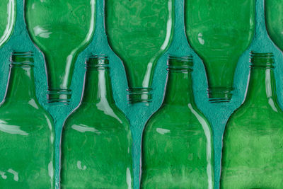 Pattern of green glass bottles stamped on wall for background, wall decorative ornament